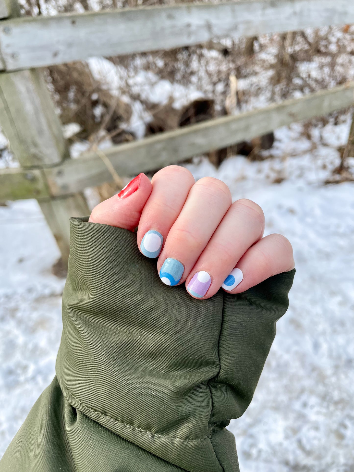 a woman's hand with a colorful manicure on it